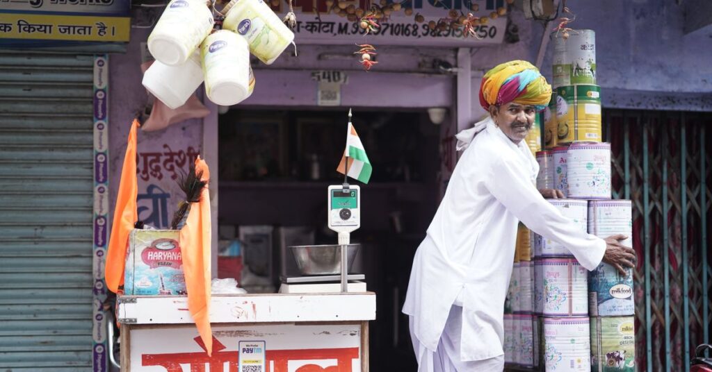 Best business ideas in India: a merchant arranging products outside his shop